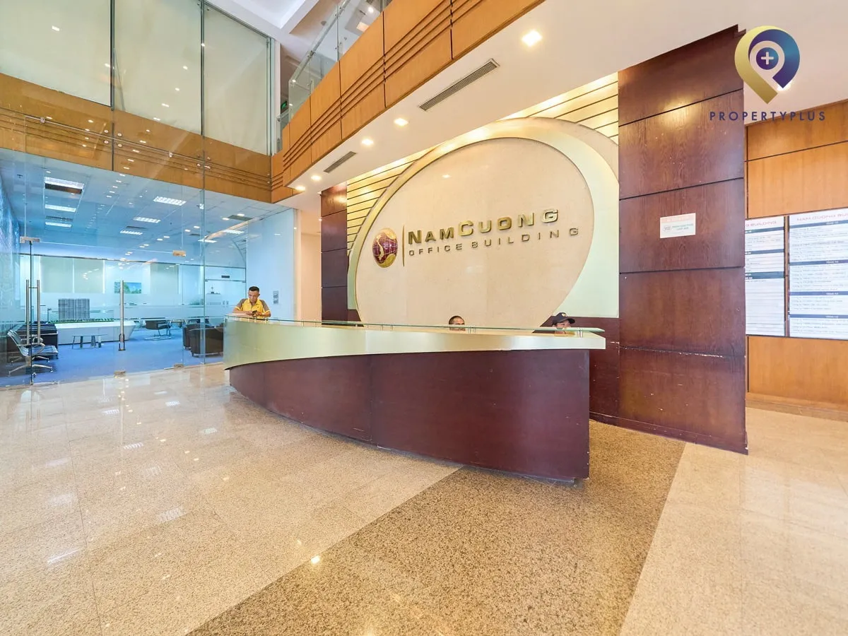 Reception desk at Nam Cuong Building with logo